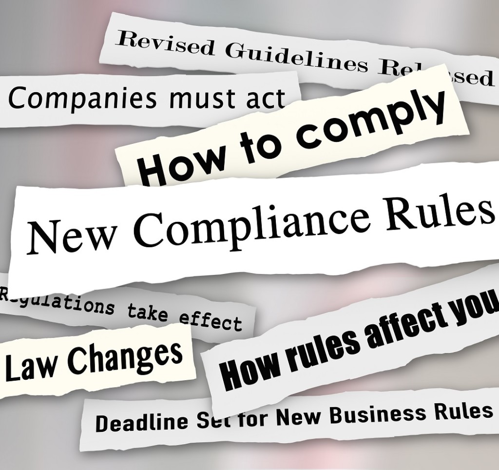 New Compliance Rules newspaper headlines words torn from the news, including Revised Guidelines Released, Law Changes, How to Comply and more