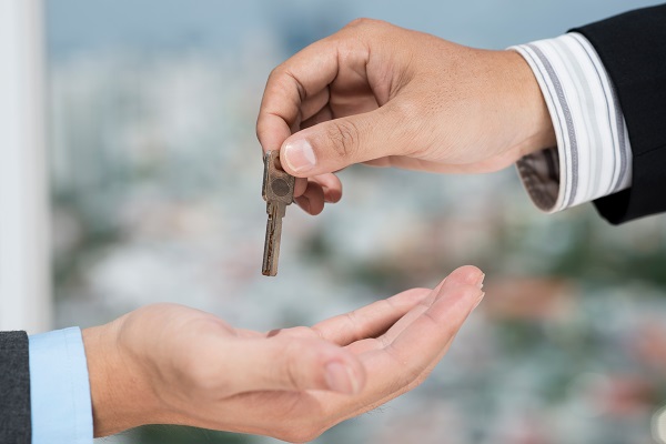 Real estate broker giving the key to the client