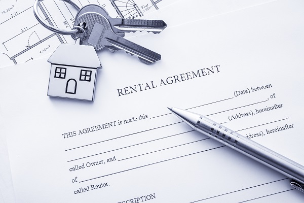 Rental agreement document with keys and pencil