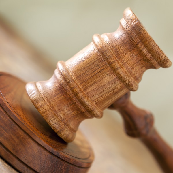 Wooden gavel in closeup, with blurred background.