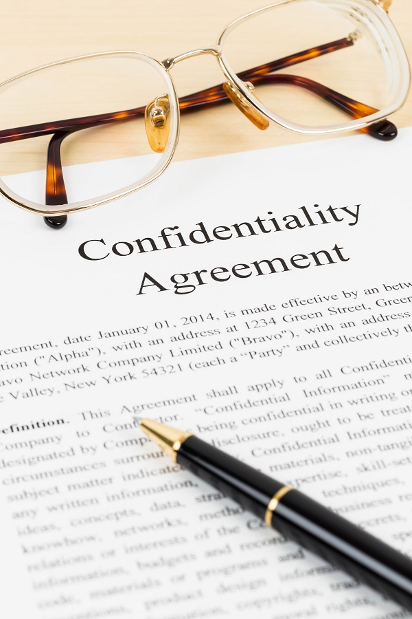Confidentiality agreement document with glasses close-up